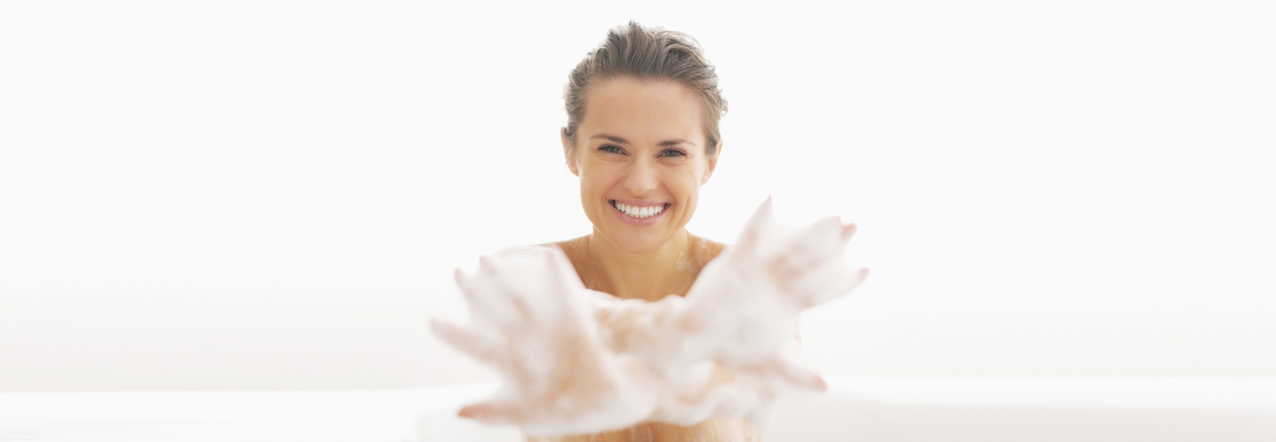 Smiling Young Woman Showing Hands In Foam
